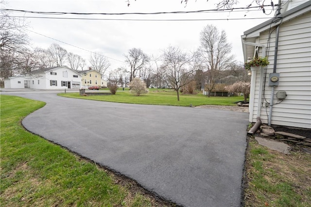 exterior space featuring a residential view and aphalt driveway
