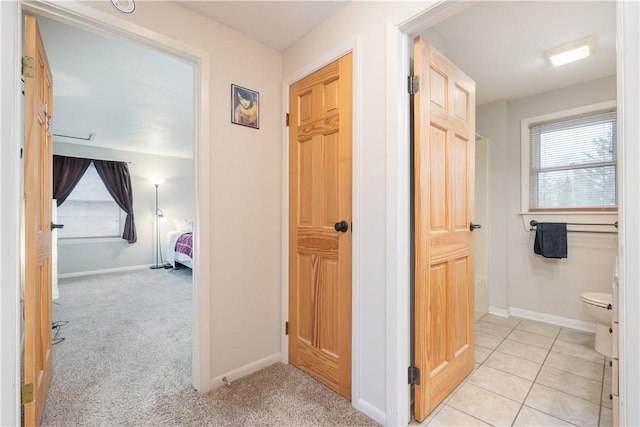 corridor with plenty of natural light and baseboards