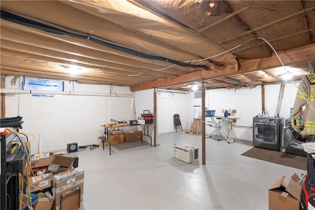 unfinished basement with washing machine and dryer