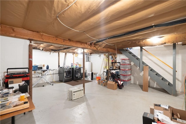 unfinished below grade area with water heater, washing machine and clothes dryer, and stairway