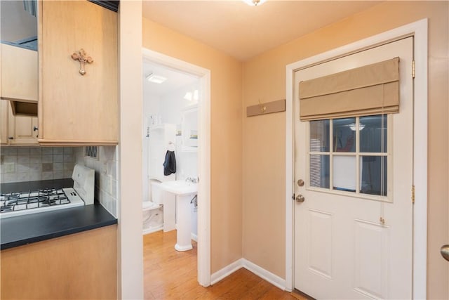 entryway with wood finished floors and baseboards