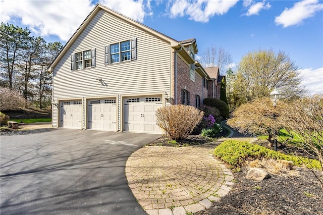 5 Ponds Edge Way, Pittsford, NY 14534 - view of side of property with brick siding, aphalt driveway, and a garage