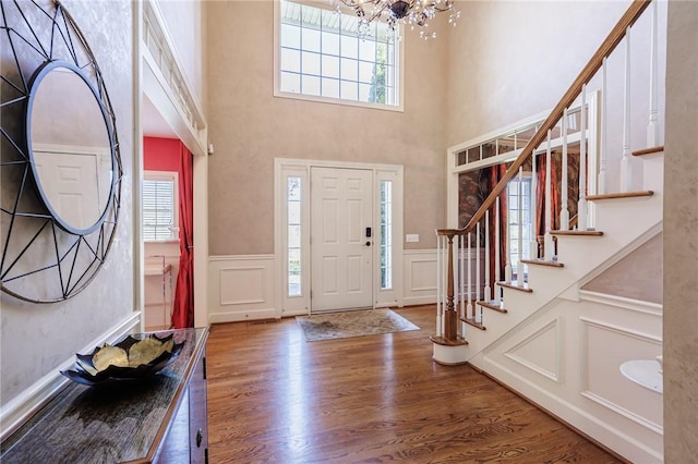 5 Ponds Edge Way, Pittsford, NY 14534 - entrance foyer with a decorative wall, wood finished floors, stairs, a wainscoted wall, and a notable chandelier