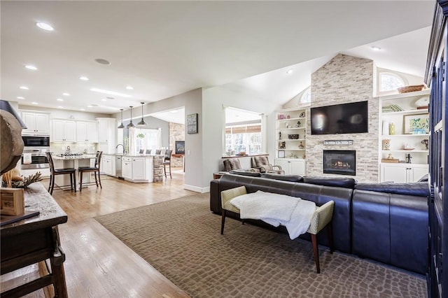 5 Ponds Edge Way, Pittsford, NY 14534 - living room with recessed lighting, lofted ceiling, light wood-style floors, baseboards, and a fireplace