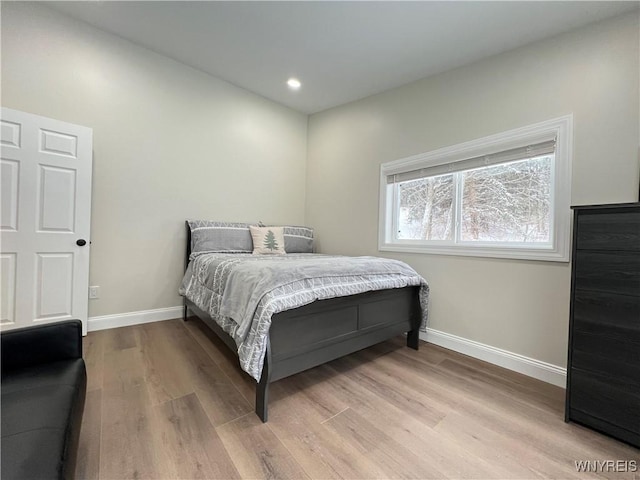 bedroom with light wood-style flooring, baseboards, and recessed lighting