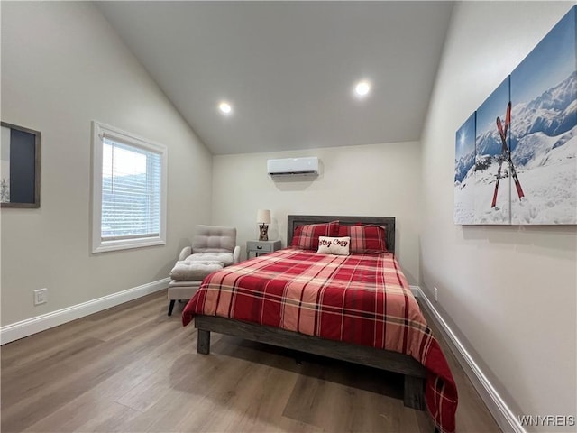 bedroom with an AC wall unit, wood finished floors, baseboards, lofted ceiling, and recessed lighting