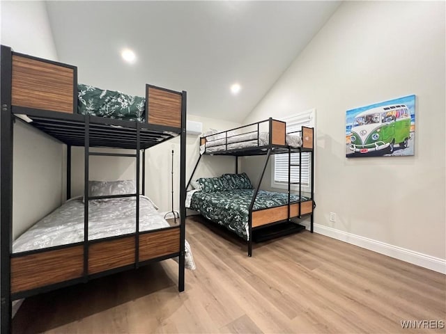 bedroom with baseboards, wood finished floors, recessed lighting, and high vaulted ceiling