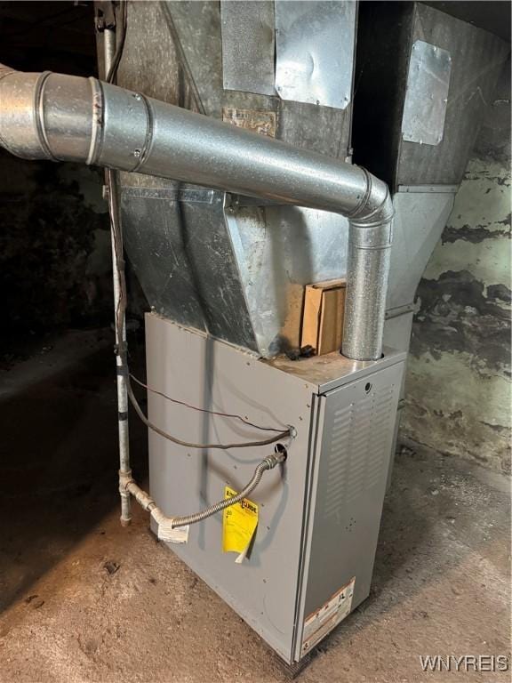 utility room featuring heating unit