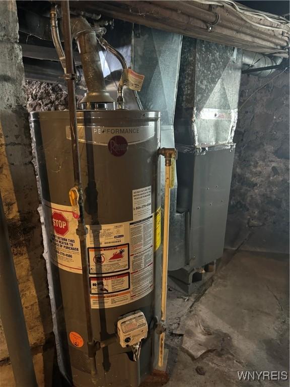 utility room featuring water heater