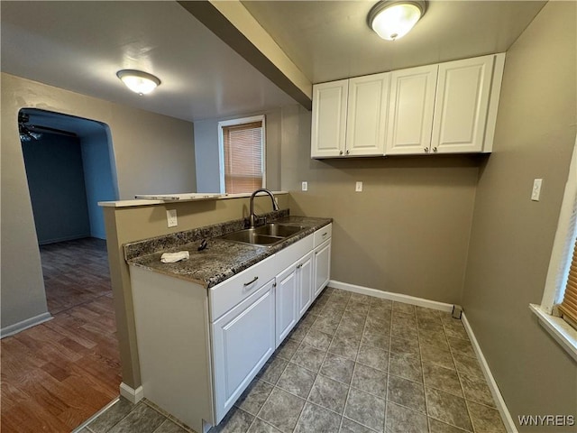 laundry area featuring baseboards and a sink