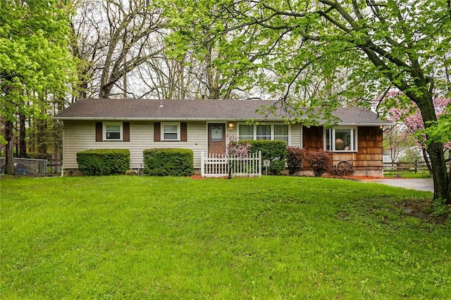 single story home featuring fence and a front lawn
