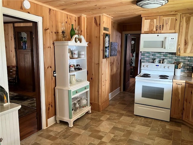 kitchen with wood walls, wooden ceiling, white appliances, and tasteful backsplash