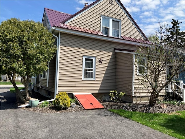 view of side of home with metal roof