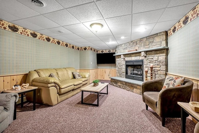 carpeted living room featuring wainscoting, wallpapered walls, and visible vents