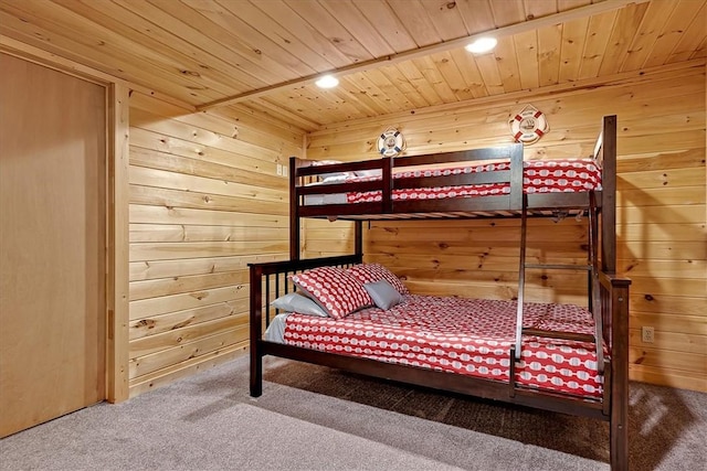 bedroom with wood ceiling, wooden walls, carpet floors, and recessed lighting