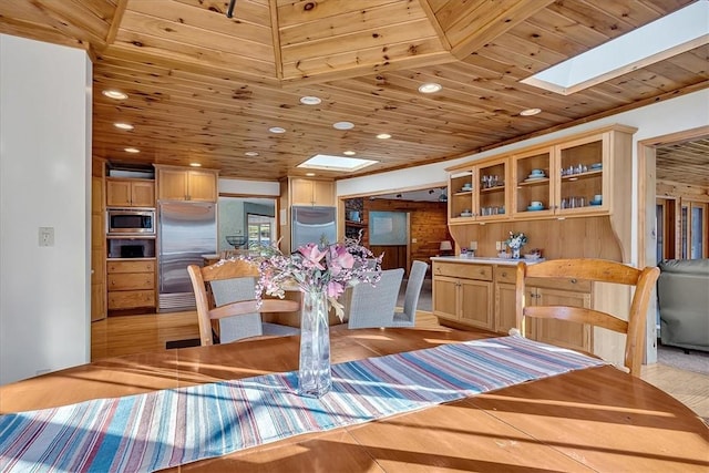 dining space featuring recessed lighting, a skylight, and wood ceiling