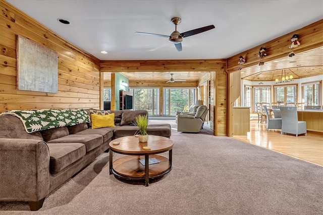 living area featuring recessed lighting, a ceiling fan, wooden walls, and carpet