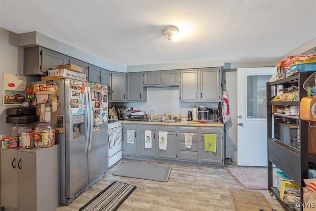 19 Whig Hill Rd, West Monroe, NY 13167 - kitchen featuring white gas range oven, gray cabinets, stainless steel refrigerator with ice dispenser, and light wood-style flooring
