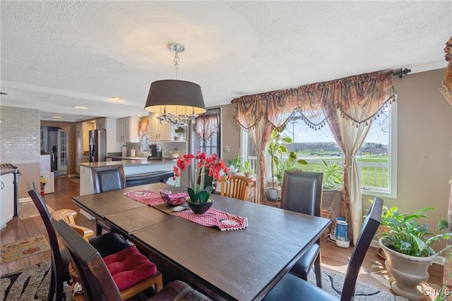 19 Whig Hill Rd, West Monroe, NY 13167 - dining room with a textured ceiling, wood finished floors, a chandelier, and arched walkways