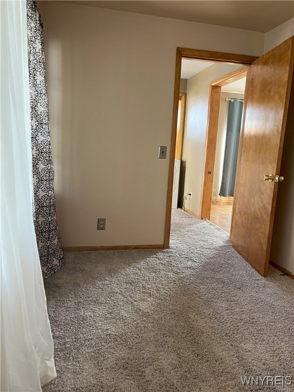 carpeted spare room with baseboards