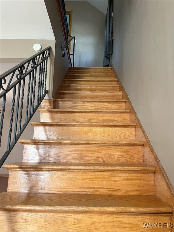stairs with vaulted ceiling