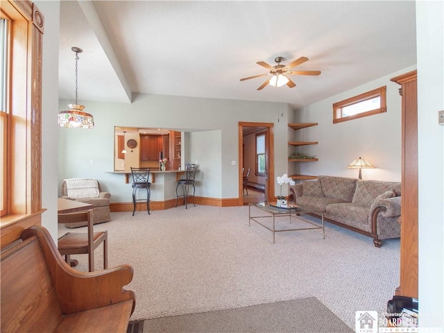 carpeted living room featuring a ceiling fan, baseboards, and a baseboard radiator