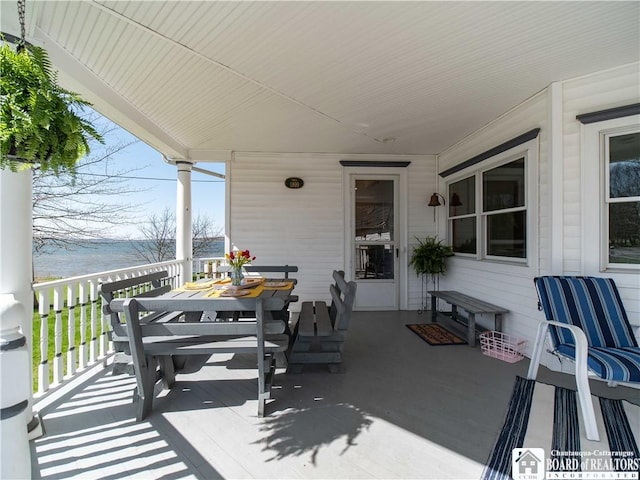 view of patio featuring outdoor dining space and a water view
