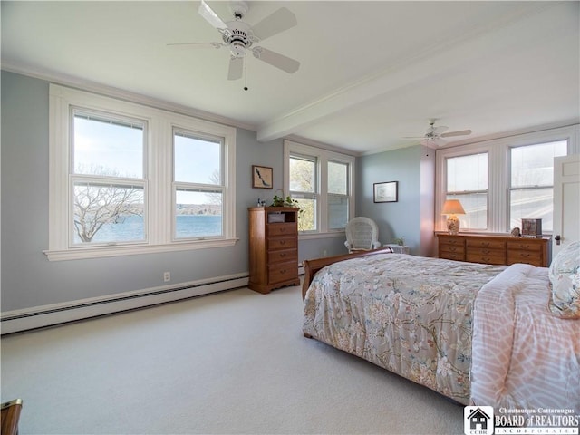 carpeted bedroom with a baseboard radiator, beam ceiling, crown molding, and ceiling fan
