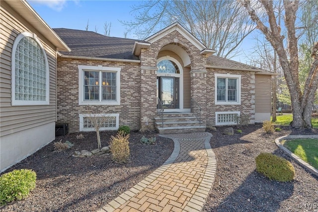 6455 Electric Railway, Cicero, NY 13039 - doorway to property with a shingled roof and brick siding
