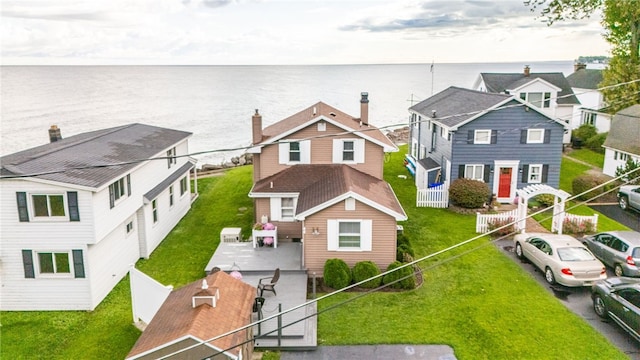 view of front of property featuring a patio area, a fenced backyard, and a residential view