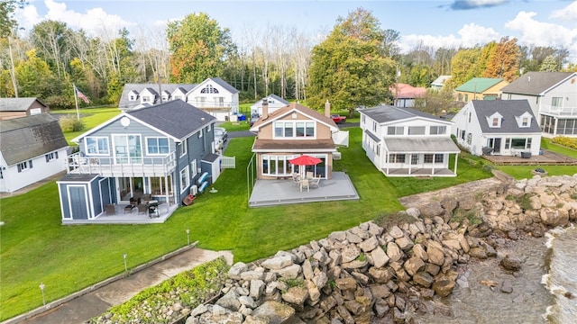 rear view of property with a residential view, a wooden deck, a patio area, a yard, and outdoor dining space