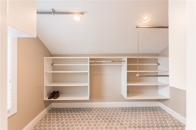 walk in closet featuring vaulted ceiling