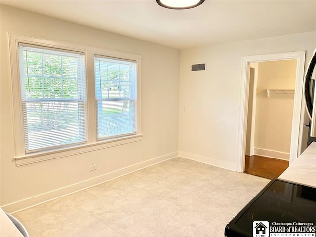 interior space with tile patterned floors, baseboards, and visible vents