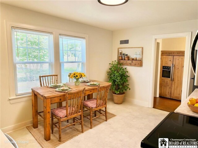 dining space featuring baseboards and visible vents