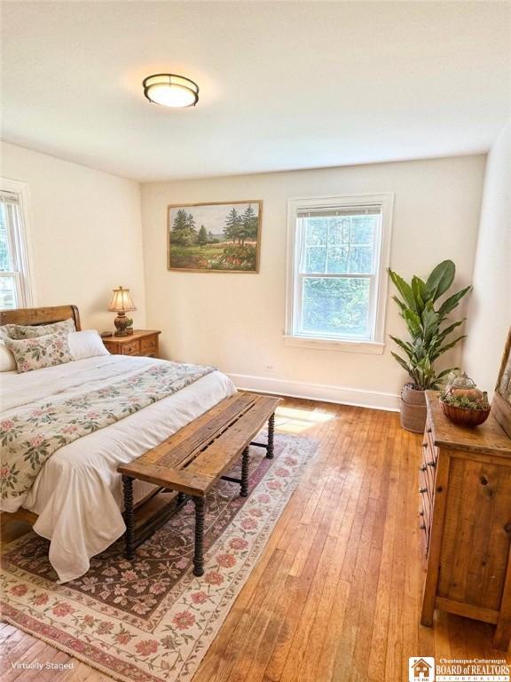 bedroom with light wood-style flooring and baseboards