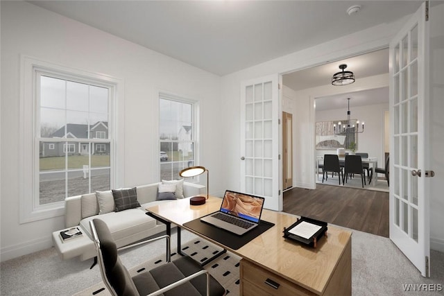 office with baseboards, a notable chandelier, french doors, and a wealth of natural light