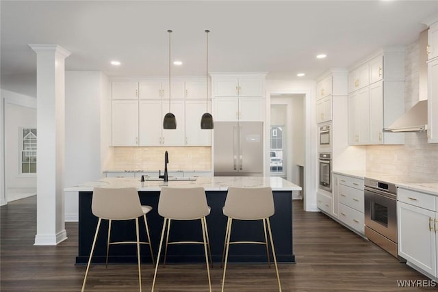 69 Woodthrush Trl, Orchard Park, NY 14127 - kitchen featuring stainless steel appliances, decorative backsplash, recessed lighting, a kitchen island with sink, and a kitchen bar