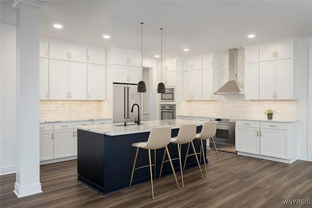 69 Woodthrush Trl, Orchard Park, NY 14127 - kitchen with appliances with stainless steel finishes, wall chimney exhaust hood, dark wood-style floors, white cabinetry, and backsplash