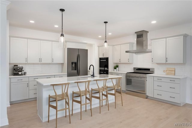 69 Woodthrush Trl, Orchard Park, NY 14127 - kitchen with appliances with stainless steel finishes, wall chimney range hood, decorative backsplash, a kitchen breakfast bar, and recessed lighting