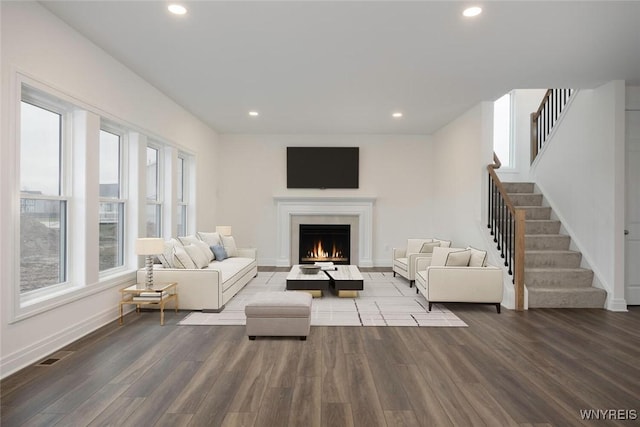 living area featuring visible vents, recessed lighting, wood finished floors, and stairway
