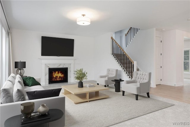 69 Woodthrush Trl, Orchard Park, NY 14127 - living room with a premium fireplace, healthy amount of natural light, and stairway