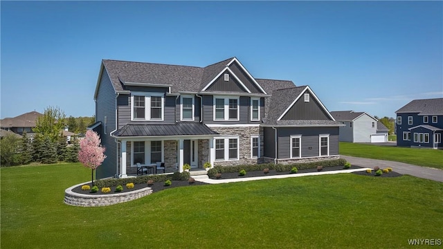 69 Woodthrush Trl, Orchard Park, NY 14127 - craftsman inspired home featuring a porch, stone siding, a front yard, and board and batten siding