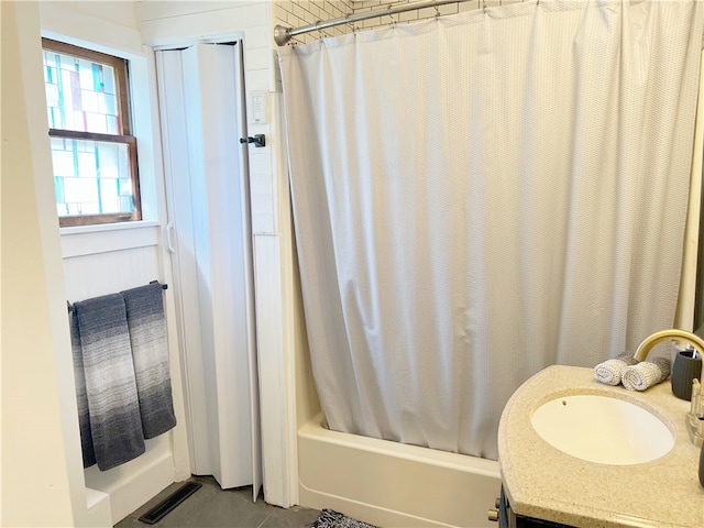 bathroom featuring vanity, visible vents, and shower / bathtub combination with curtain