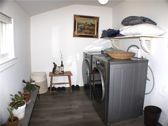 clothes washing area with washing machine and dryer, laundry area, and dark wood finished floors
