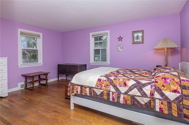 bedroom featuring baseboards and wood finished floors