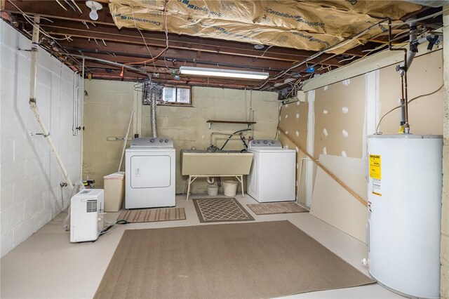 clothes washing area featuring water heater, independent washer and dryer, laundry area, and a sink