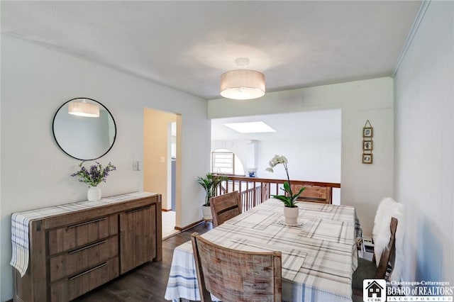 dining room with dark wood-type flooring and a skylight