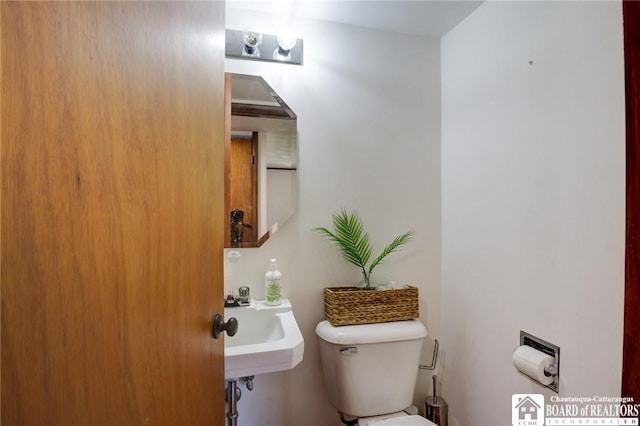 half bathroom with toilet and a sink