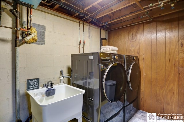 laundry room featuring washing machine and clothes dryer, a sink, and laundry area