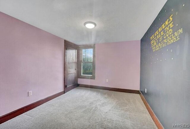 269 S Main St, Wellsville, NY 14895 - spare room featuring baseboards and carpet flooring